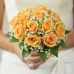 This radiant bridal bouquet, lovingly crafted for a Golders Green celebration, glows with sun-kissed peach roses arranged in perfect unity. Each rose unfurls in graceful spirals, their petals tinted with delicate notes of golden apricot and honey-shades reminiscent of summer mornings spent in local parks or strolling past the colorful shopfronts of Golders Green Road. Wisps of pure white baby's breath nestle softly between the roses, evoking the gentle haze of dawn or the subtle joy in a loved one's smile. Glossy green leaves beneath frame this harmonious cluster, blending natural simplicity with refined elegance. Bathed in soft daylight, the bouquet shimmers as a symbol of hope and joyful beginnings, perfectly suited for a bride stepping across the threshold of a new life together. Its fragrance, light and sweet, promises a day filled with affection, laughter, and the kind of beautiful memories only a wedding in Golders Green can inspire. As a florist, I treasure how this bouquet bridges cherished tradition and fresh local vibrance-each flower lovingly chosen to honour both love and community on this most special day.